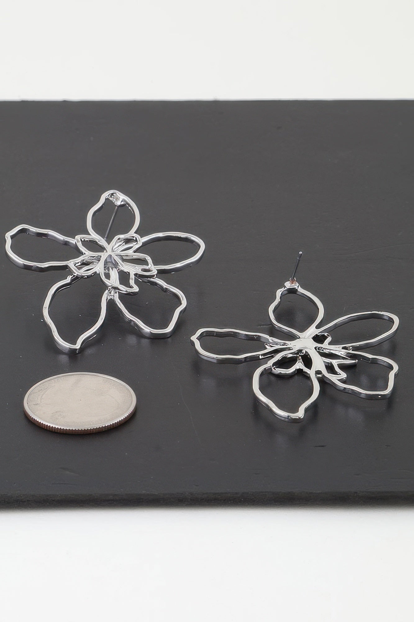 Silver-tone abstract flower drop earrings, dangling five-petal design
