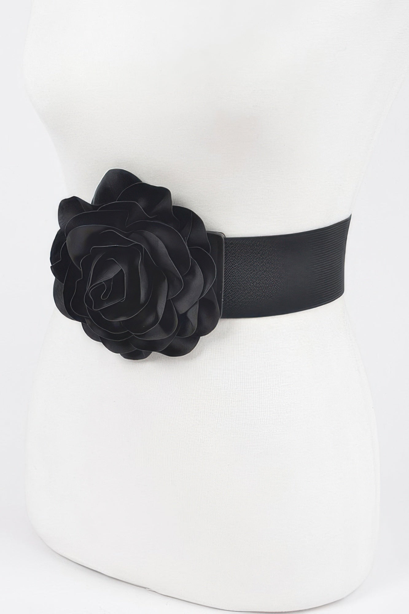 Black elastic belt with textured fabric and large flower on the left