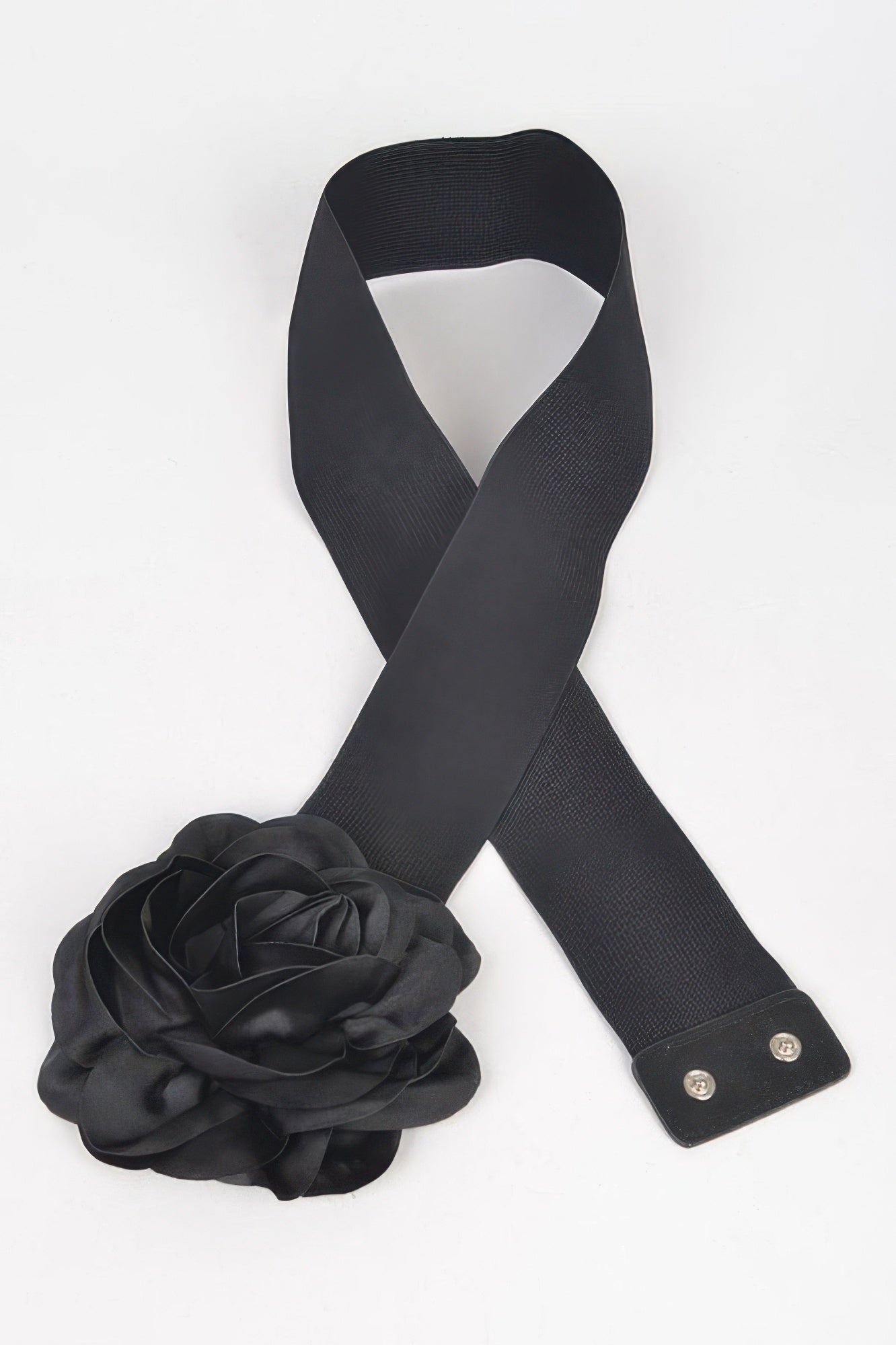 Black elastic belt with bow ends, metal snaps, and large flower accent
