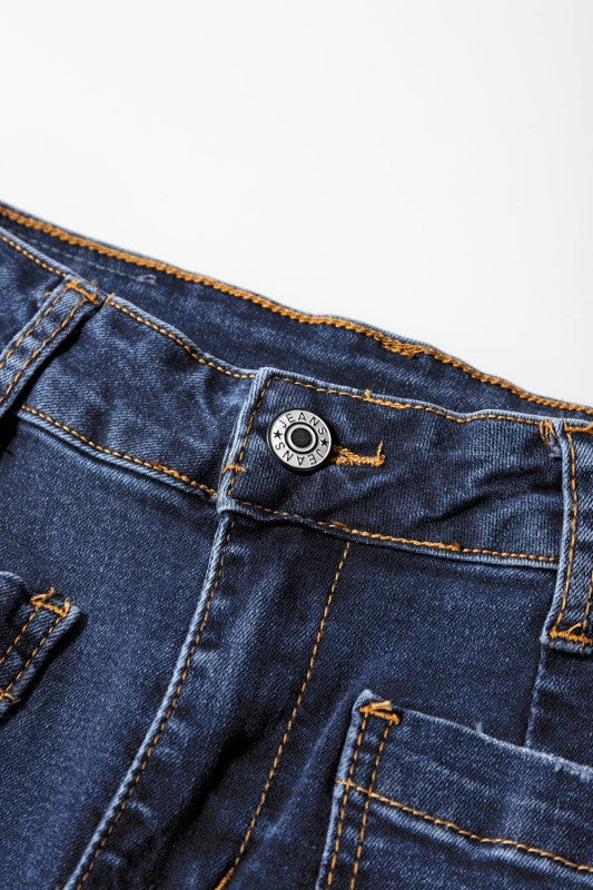 Front button waistband and stitched patch pockets on dark blue denim jeans