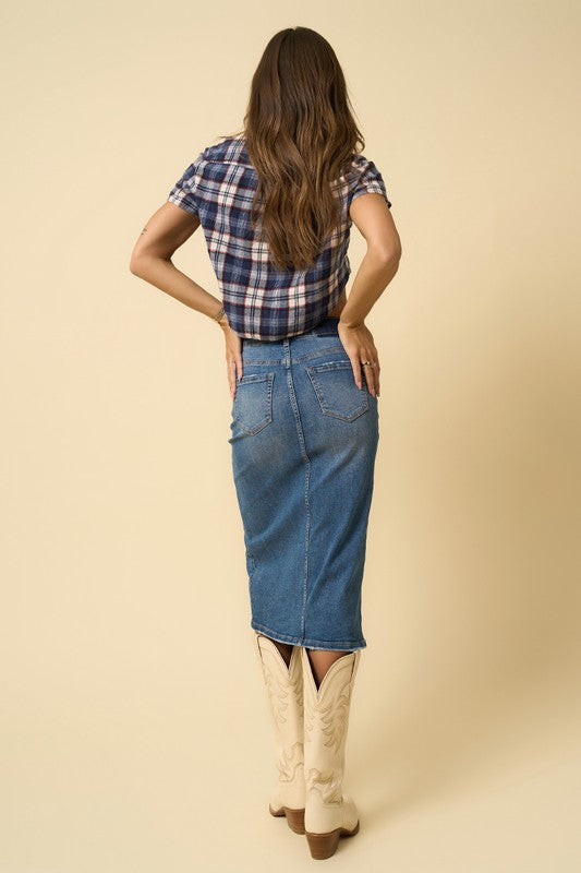 Back view of medium-wash denim midi skirt with button waistband and slit