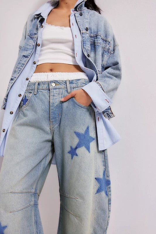 Light-wash denim jeans with blue star patches, high waist, front button