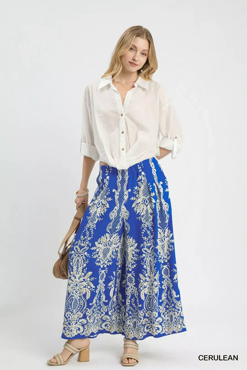 Blue border print wide-leg pants with ornate cream motifs