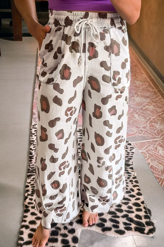 White leopard-print drawstring pants with elastic waist and front pockets