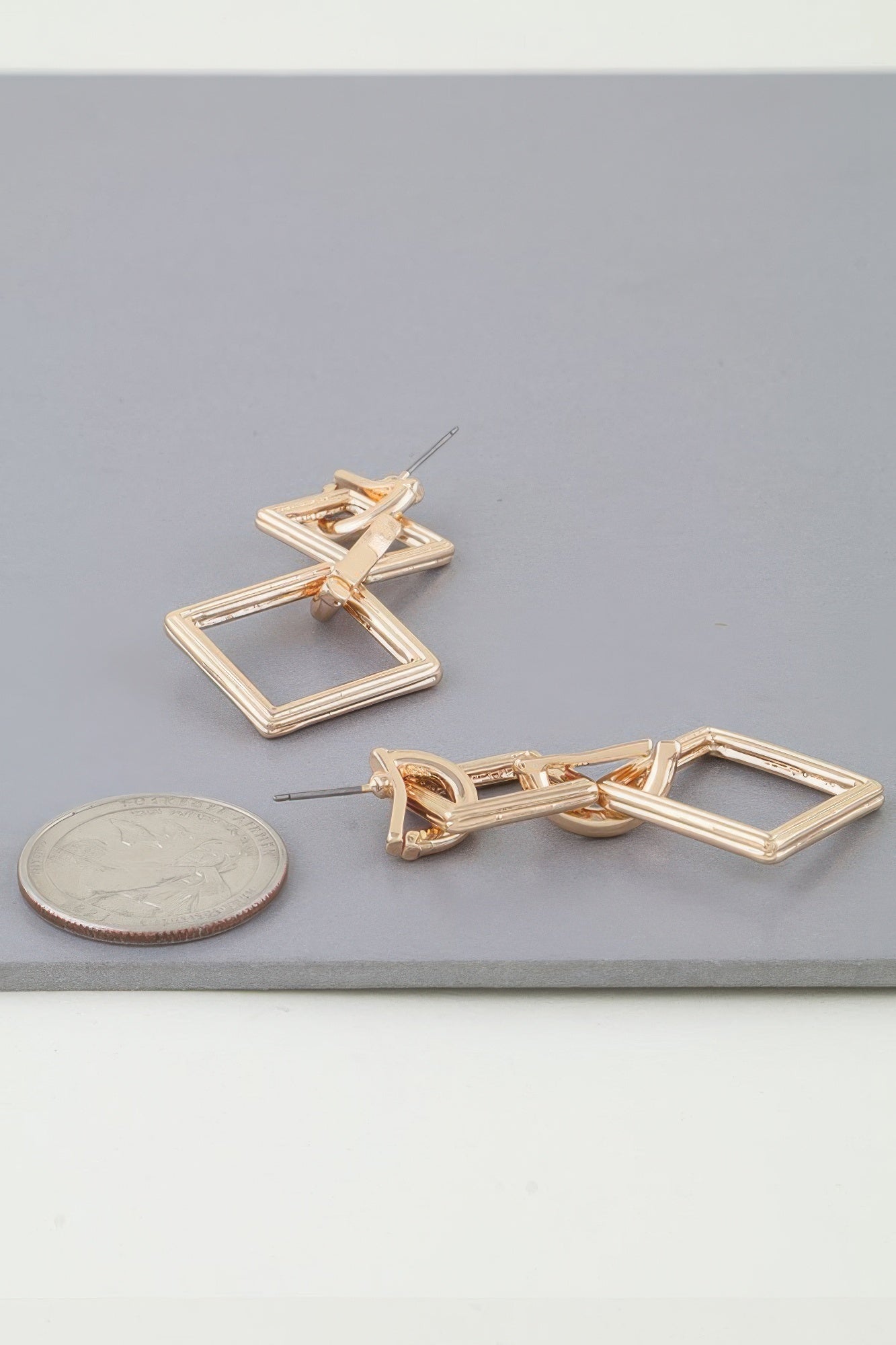 Gold-tone diamond chain drop earrings; stud back with two linked diamond frames