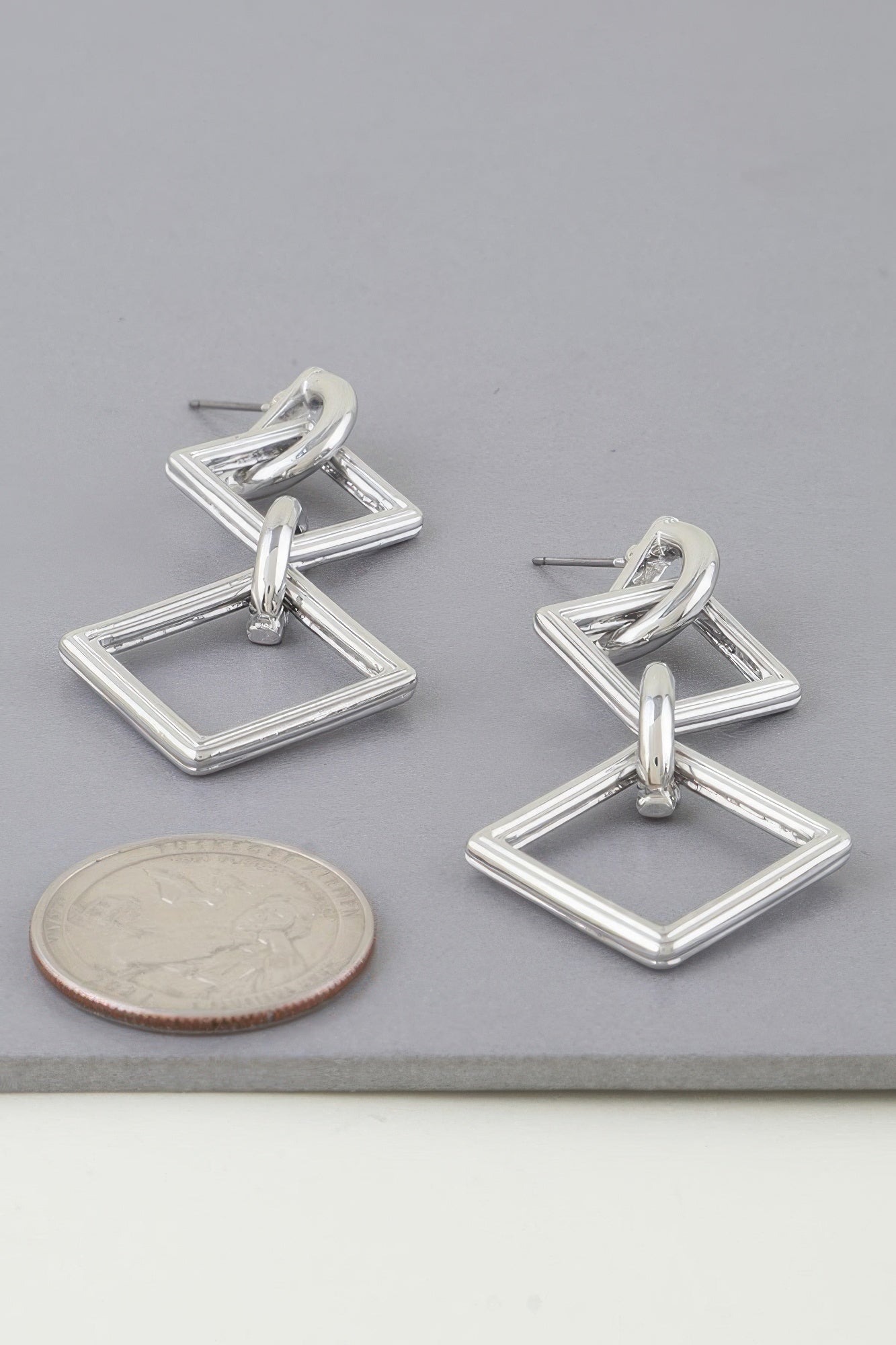 Diamond chain drop earrings with interlocking diamond shapes, silver-tone finish