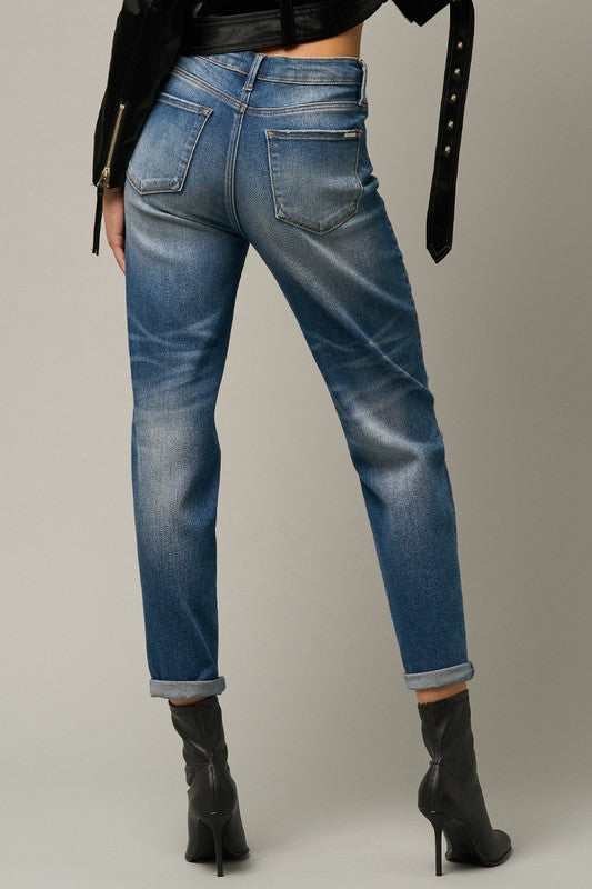 Blue distressed girlfriend jeans, side/back pocket detail with whiskered fade and cuff.