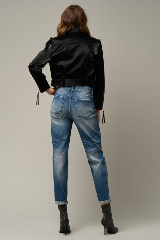 Back view of distressed girlfriend jeans in medium blue with back pockets and belt loops.