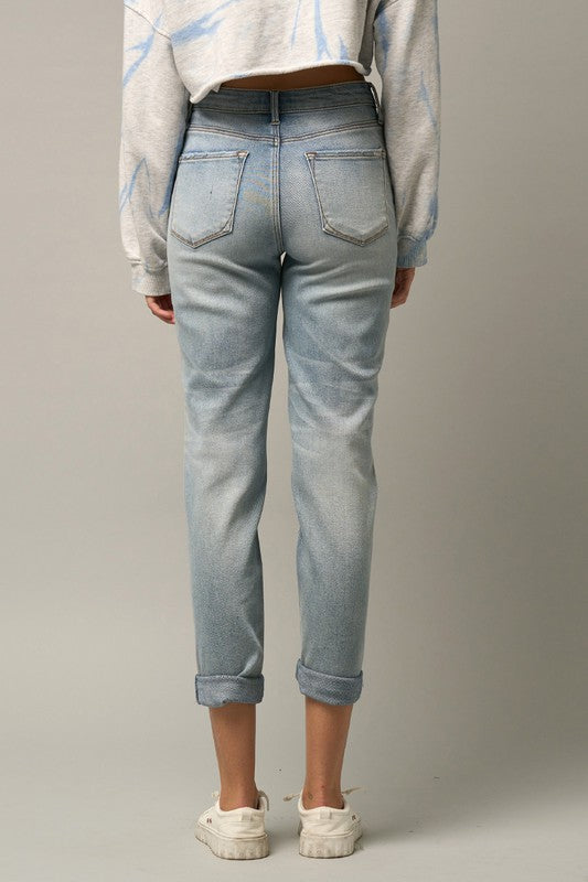 Back view: medium wash girlfriend jeans with two back pockets and cuffed hem