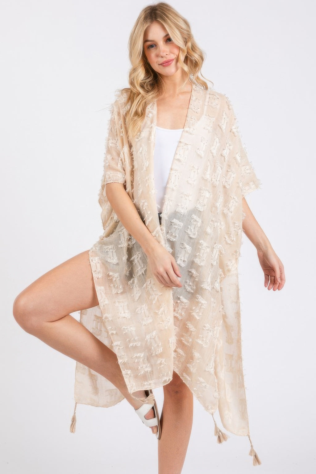 Beige distressed pattern kimono with tassel trim, draped open front and loose fit
