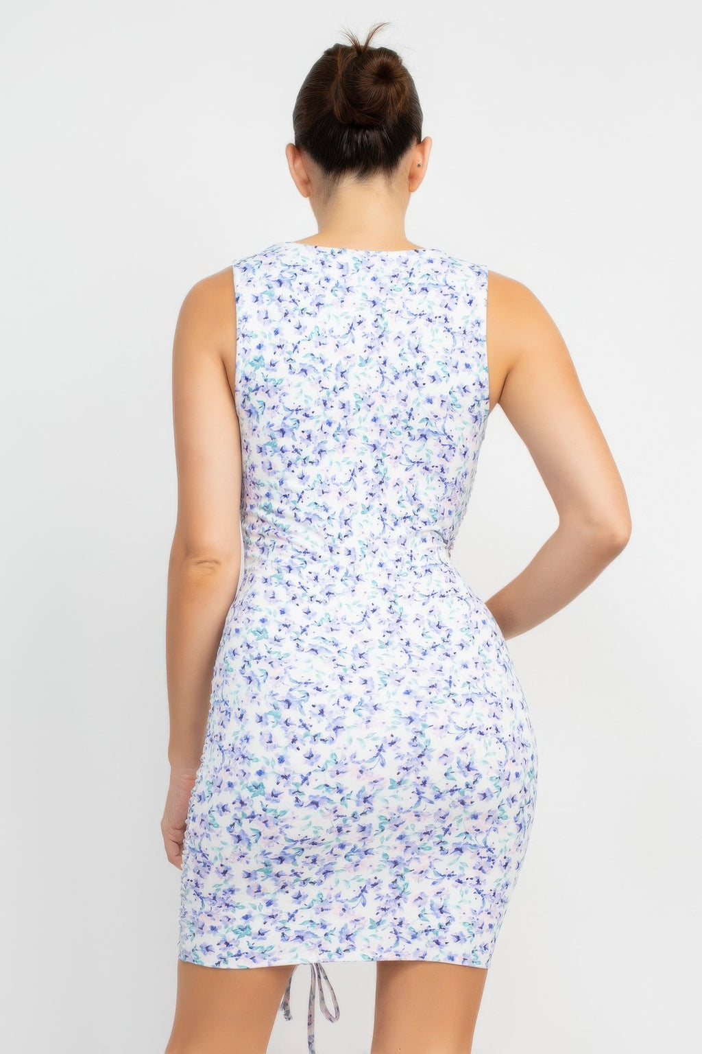 Back view of ivory/blue ditsy floral ruched mini dress with tie waist