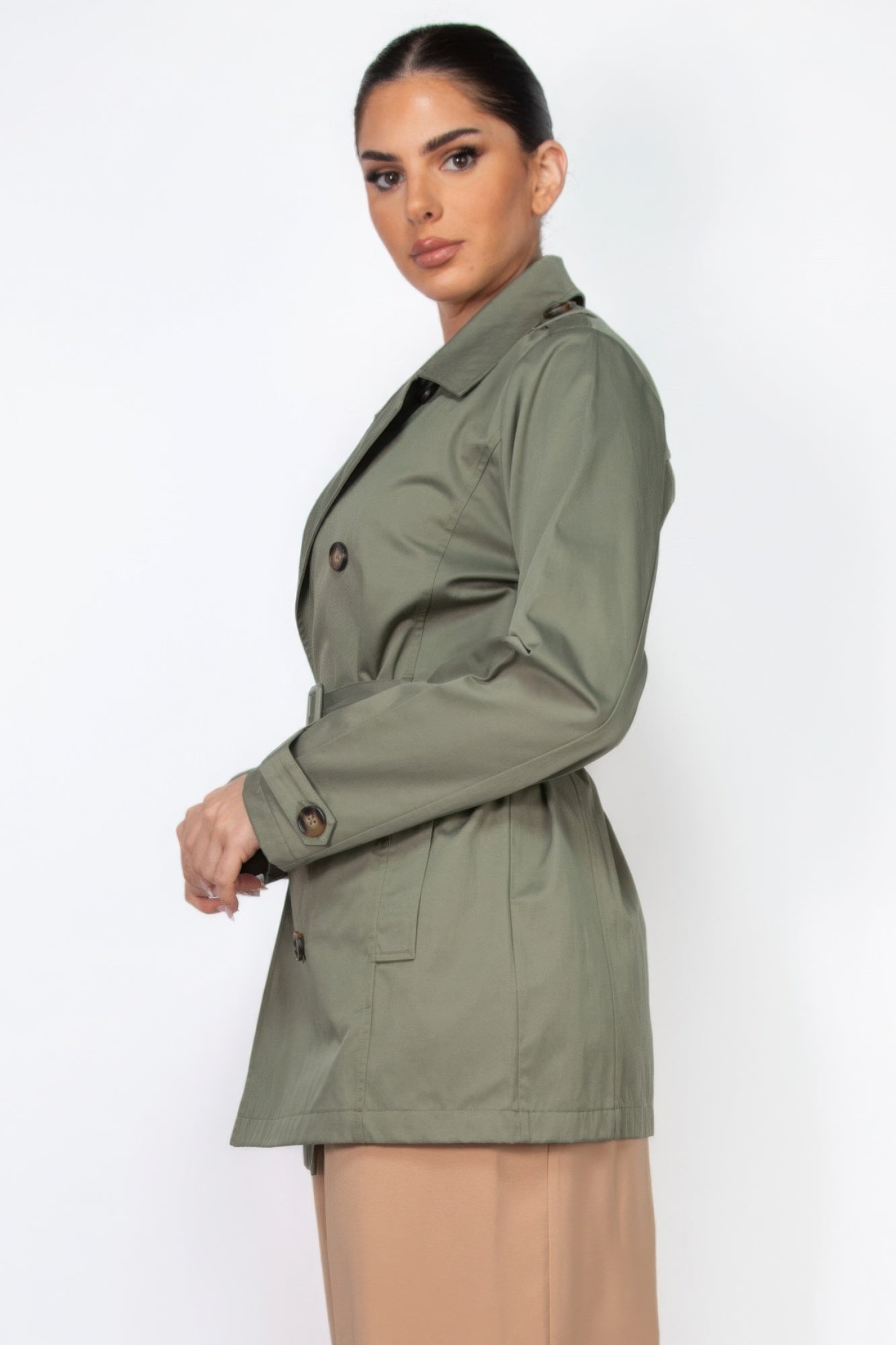 Dark olive double-breasted belted coat side view with button details and pockets