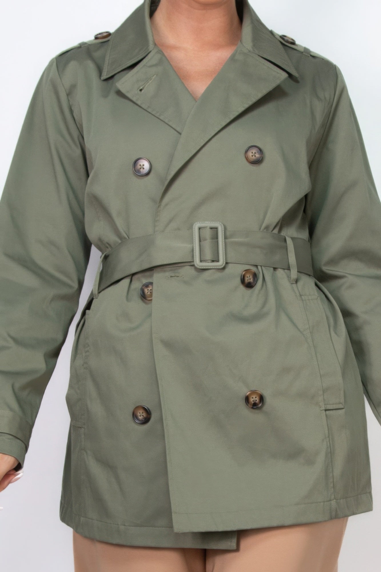 Dark olive belted double-breasted coat close-up with buttoned placket and buckle belt