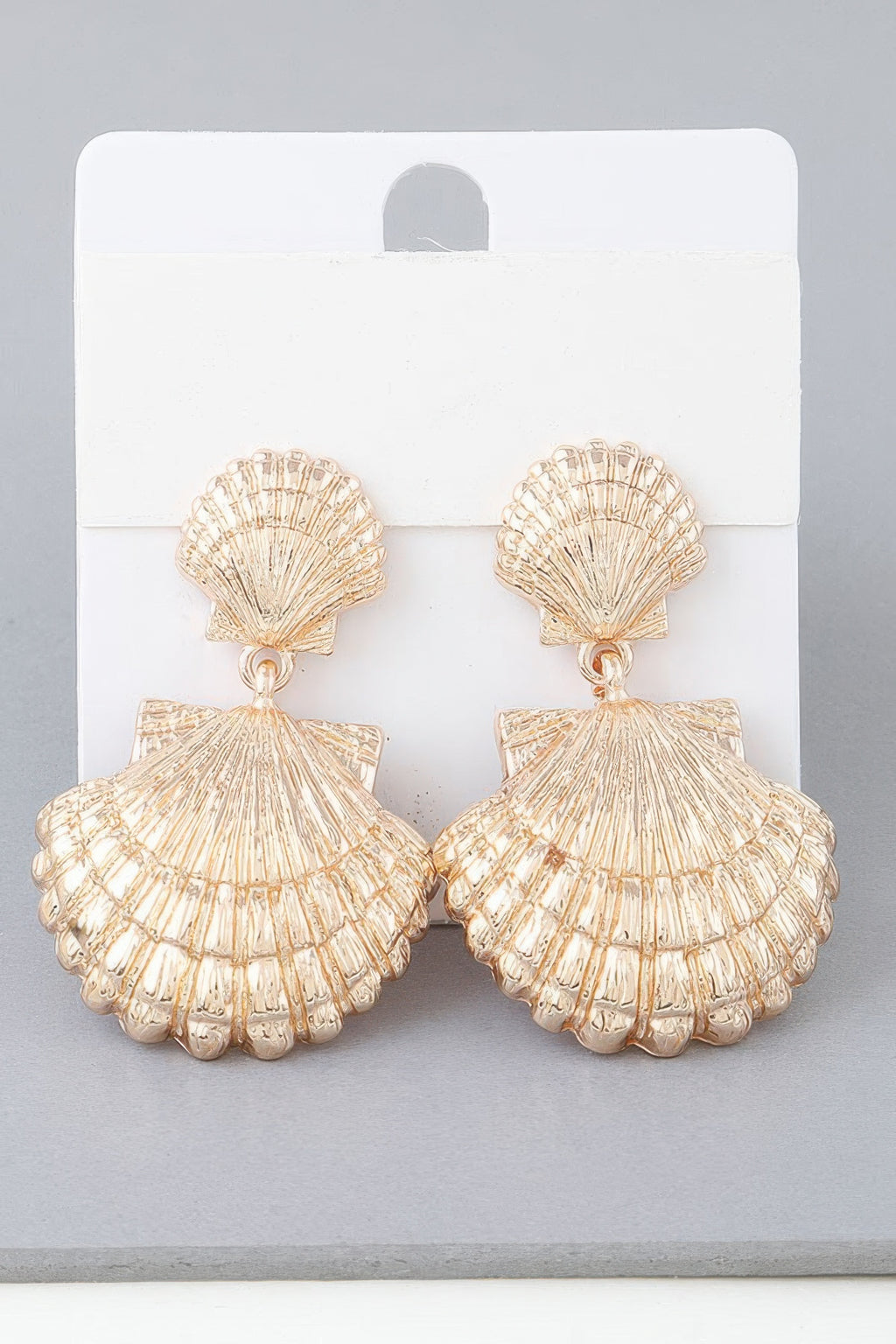 Double clamshell drop earrings in gold-tone, scalloped shell tiers with dangling charm