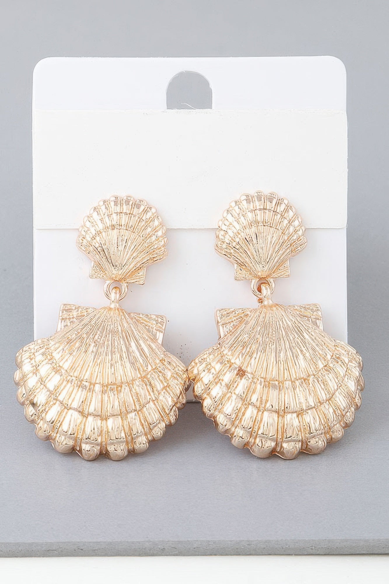 Double clamshell drop earrings in gold-tone, scalloped shell tiers with dangling charm