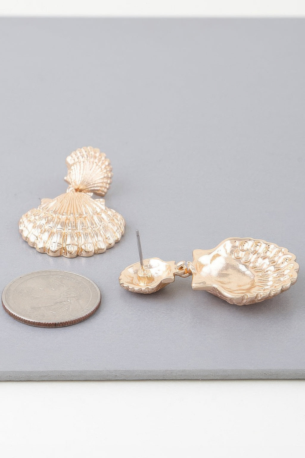 Gold-tone double clamshell drop earring pair, front view with stud posts visible