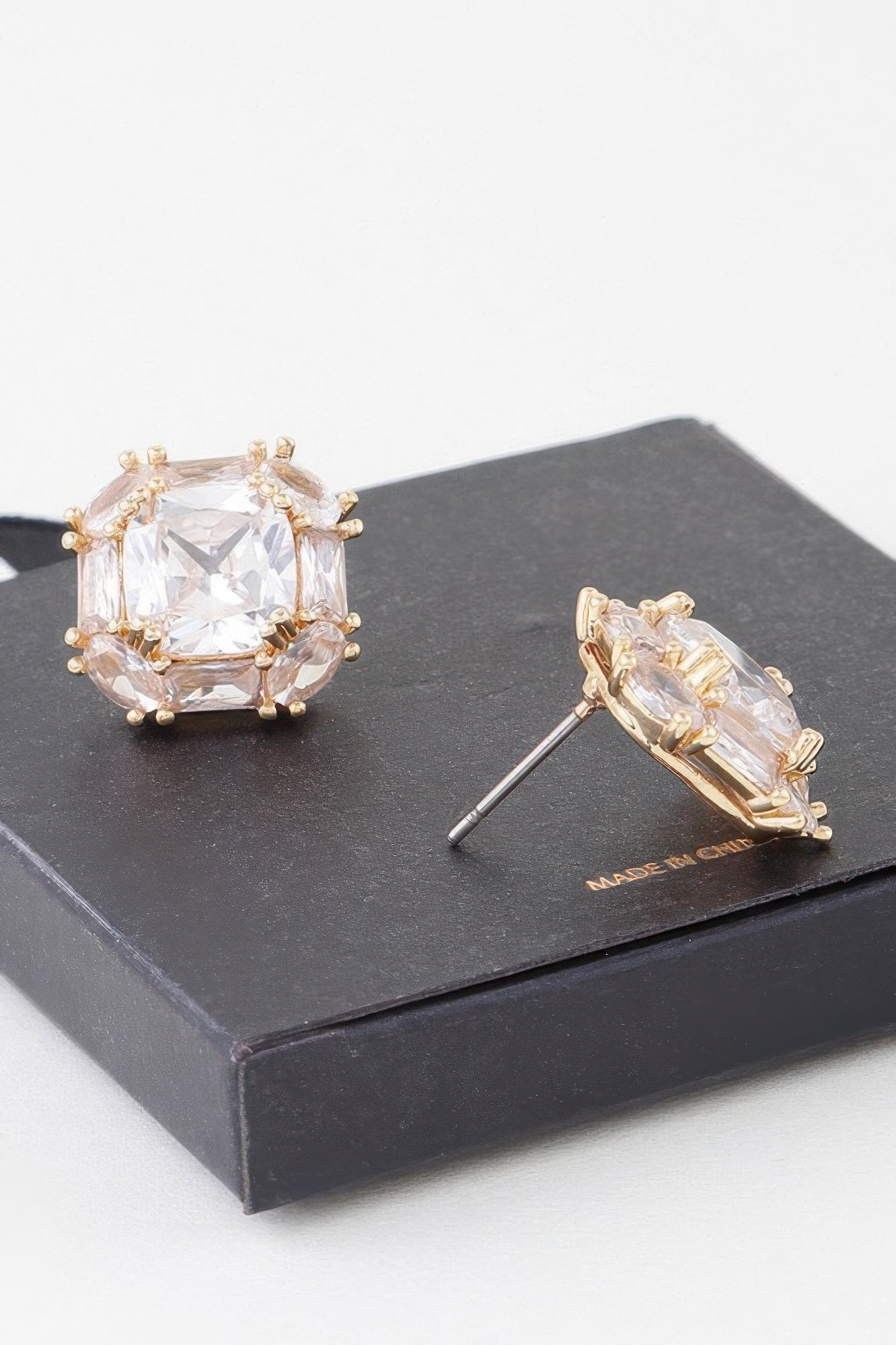 Gold-tone clear rhinestone stud earrings, princess-cut sparkle on round bezel