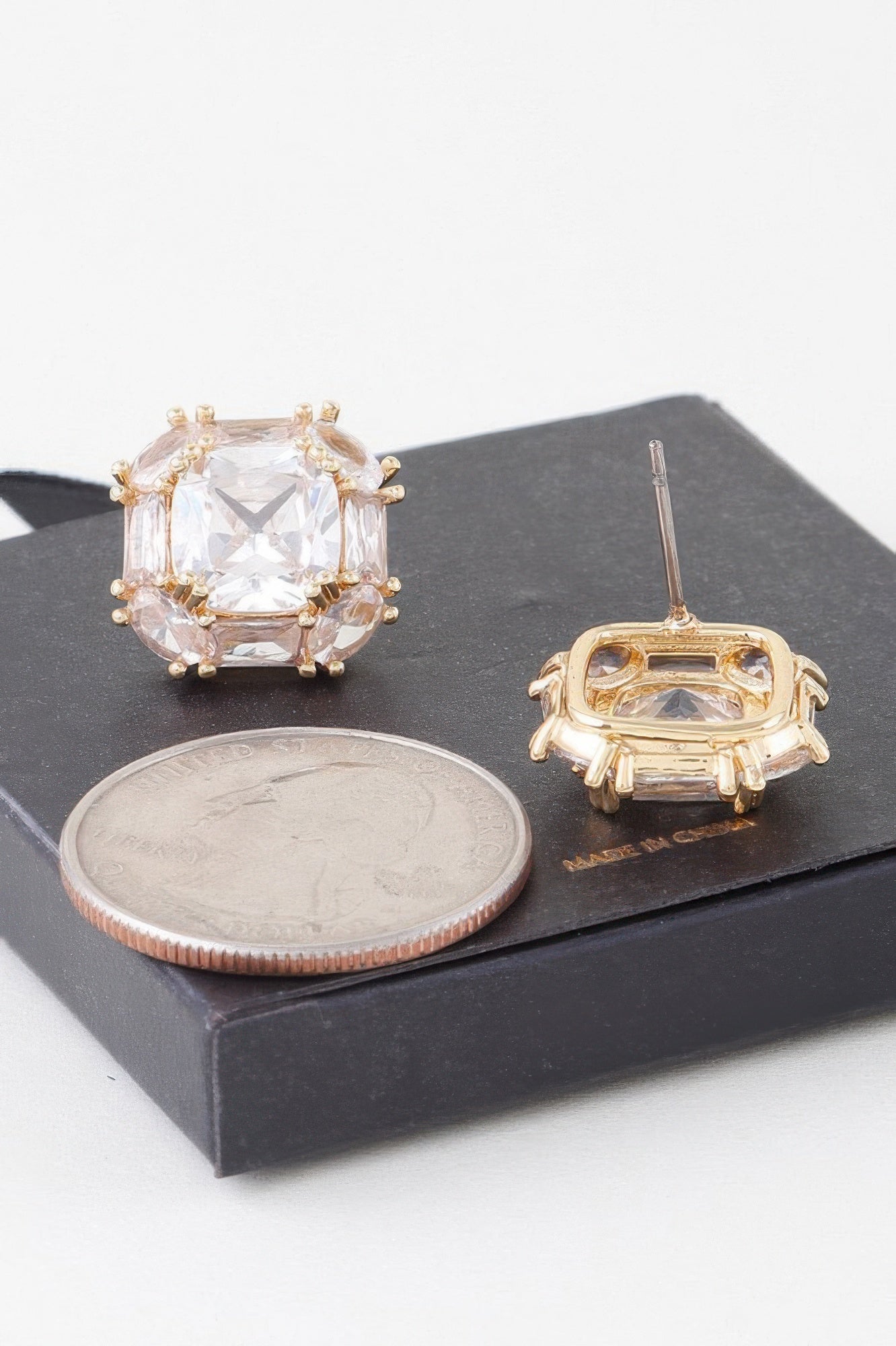 Gold-tone cubic rhinestone stud earrings with clear stones, post back shown
