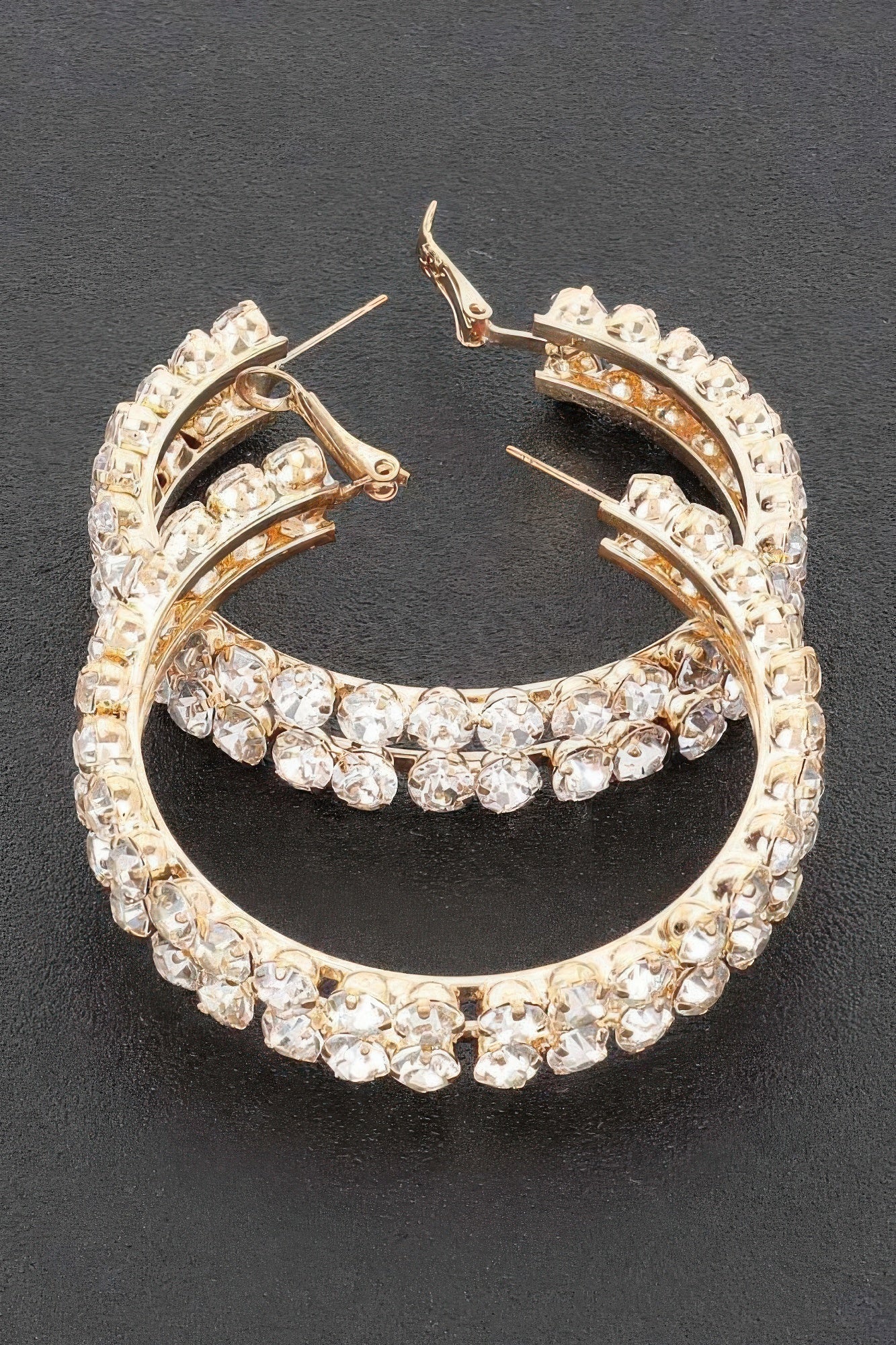 Gold double-row hoop earrings, bright rhinestones lining the outer and inner arcs