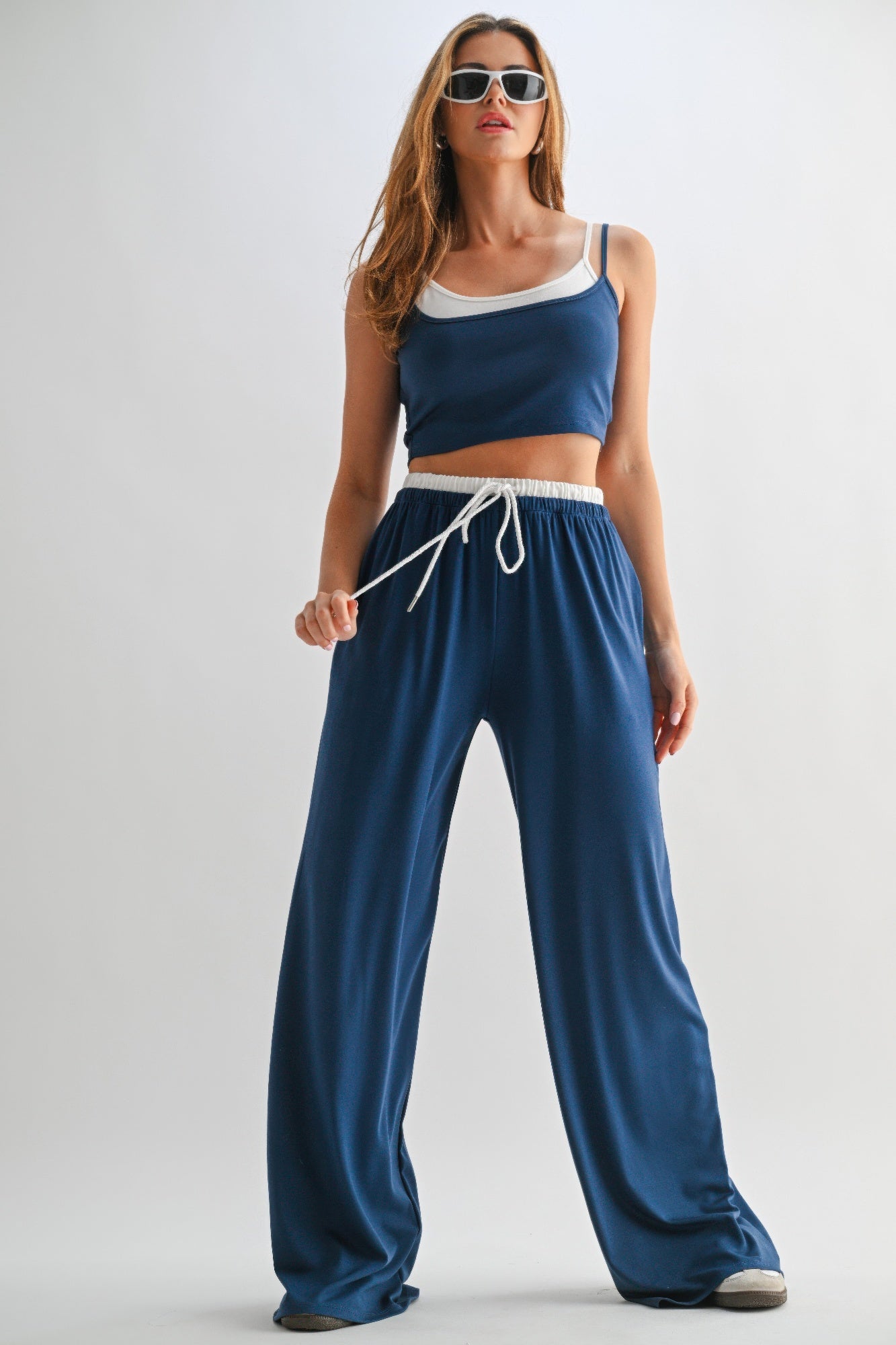 Navy drawstring lounge pants and crop top set with white trim and wide-leg fit