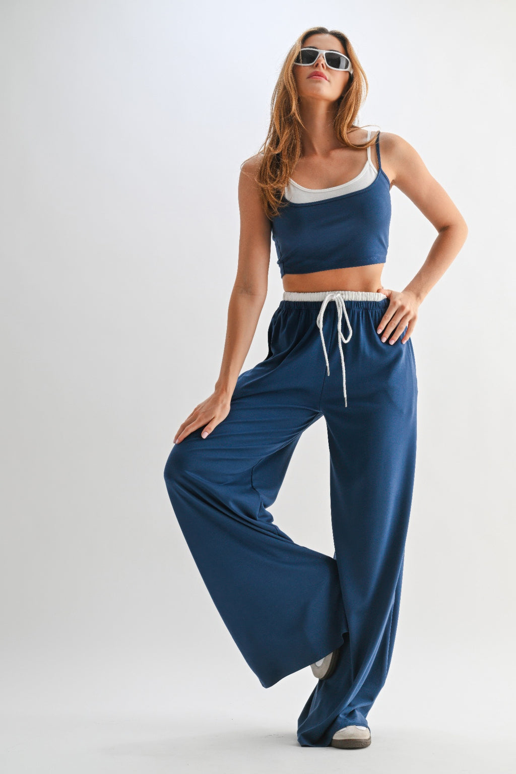 Blue lounge pants set with drawstring waist, white cord tie, and matching crop top