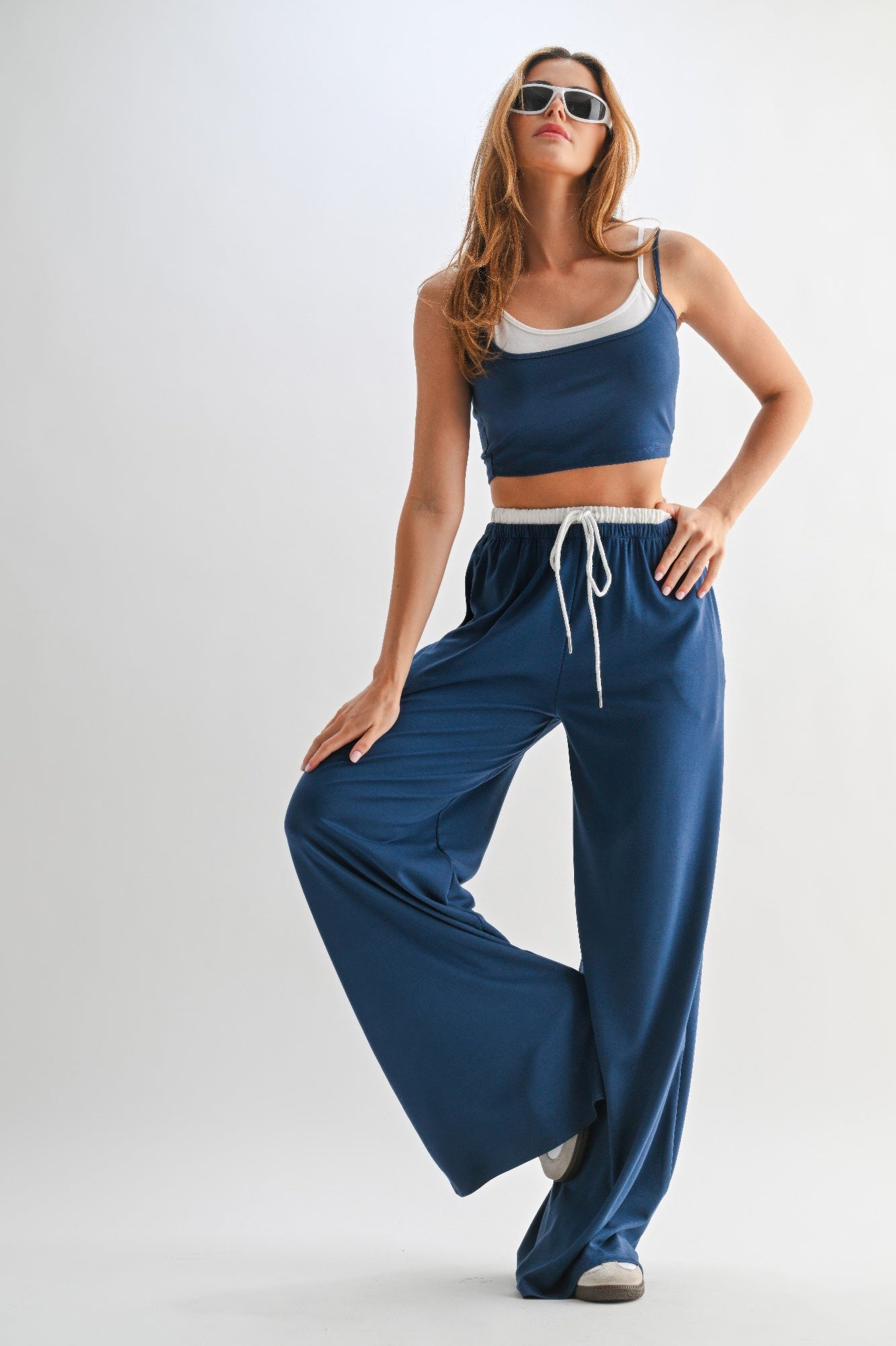Blue lounge pants set with drawstring waist, white cord tie, and matching crop top