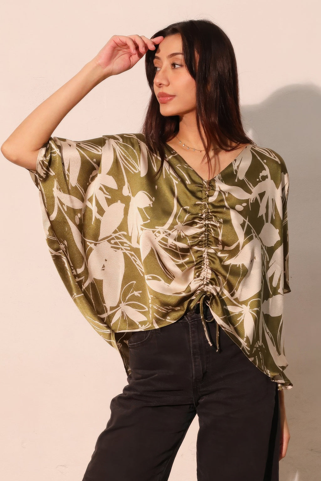 Olive satin dolman drawstring top with V-neck and ruched gathered front, floral print.