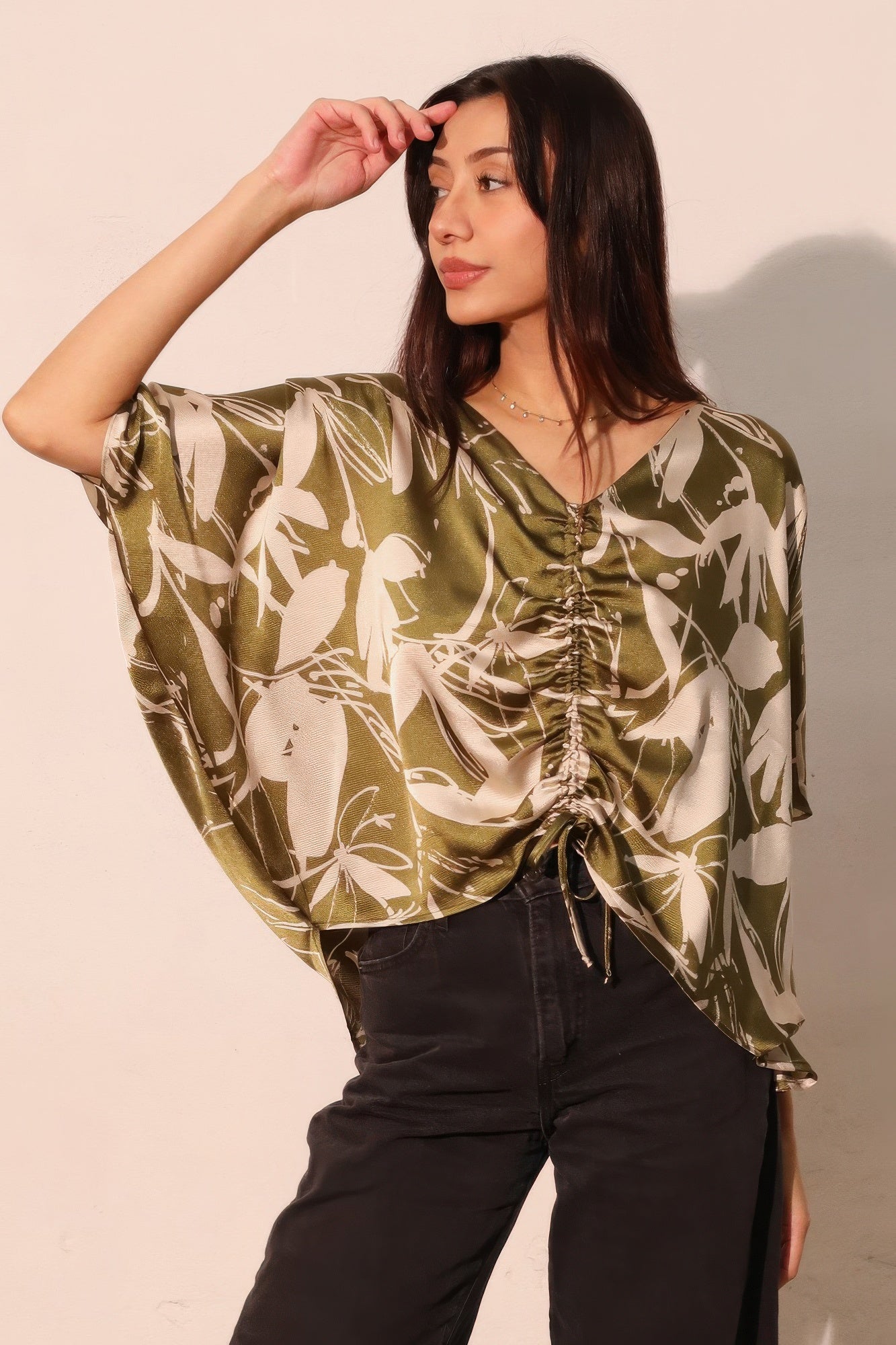 Olive satin dolman drawstring top with V-neck and ruched gathered front, floral print.