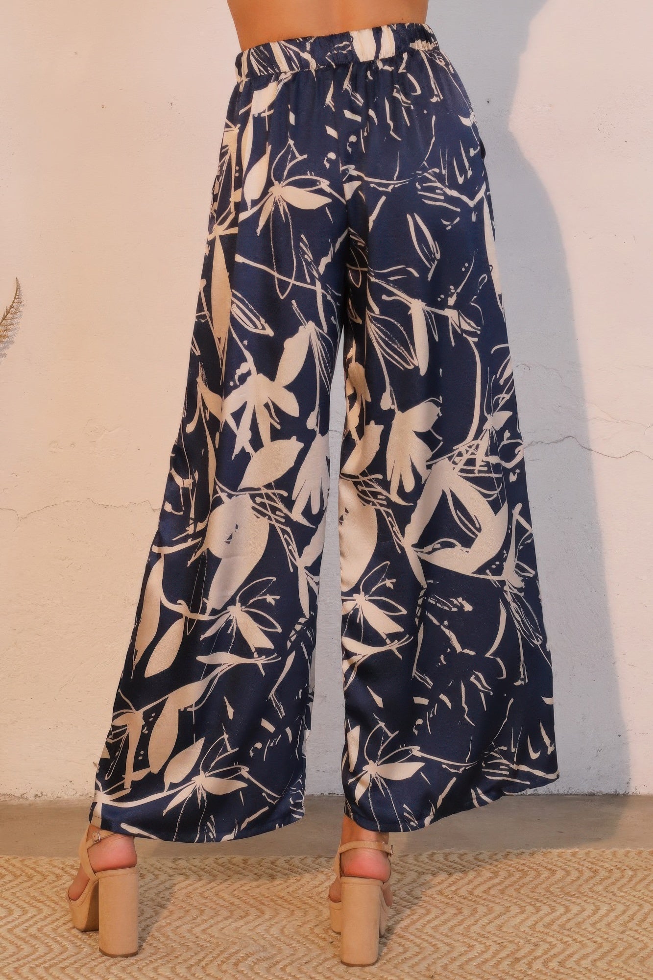 Navy satin wide-leg pants with elastic waist, allover botanical print