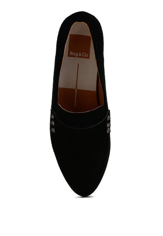 Black suede loafer top view showing stud detail near the strap opening