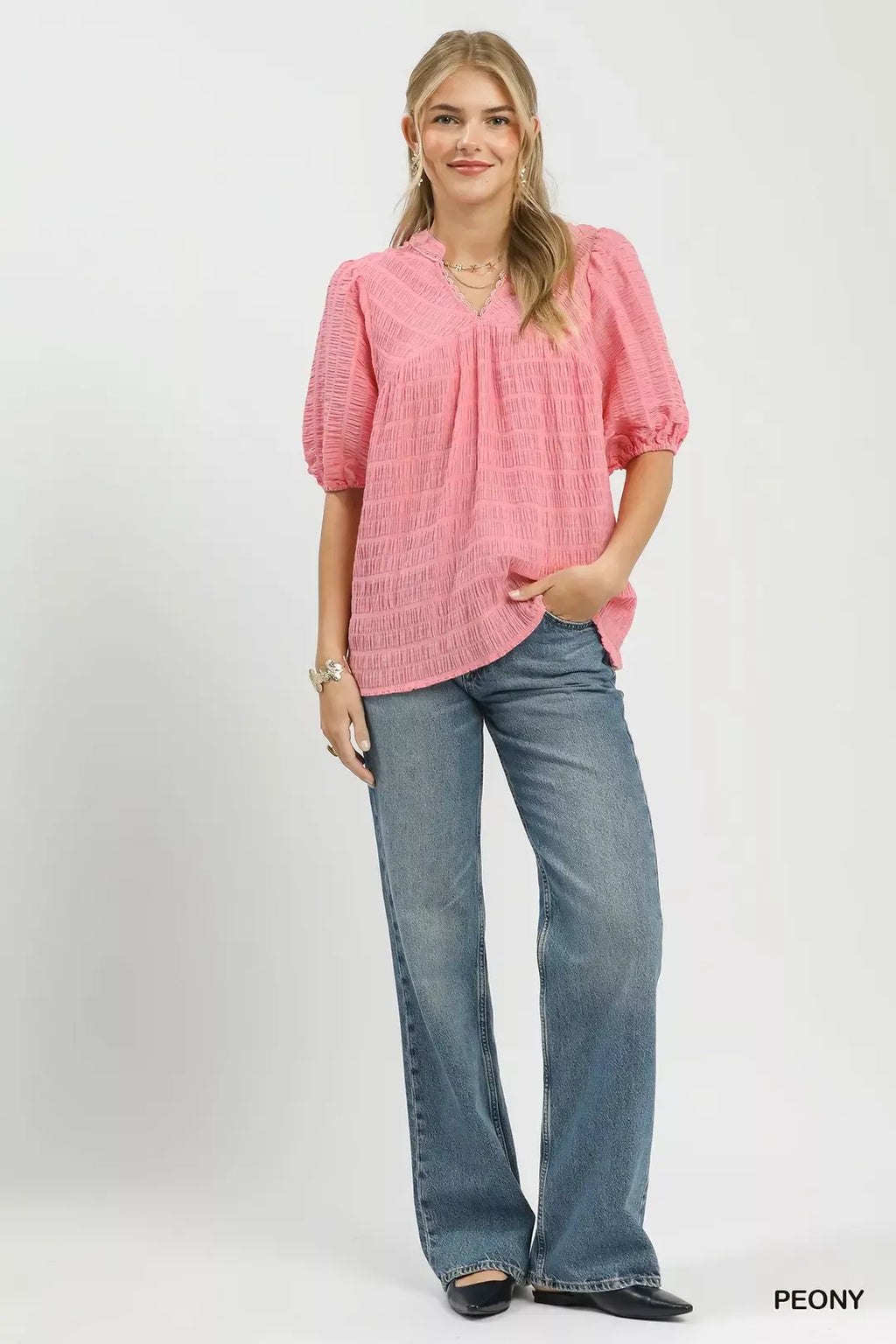 Peony textured puff-sleeve blouse with V-neck, styled with blue jeans