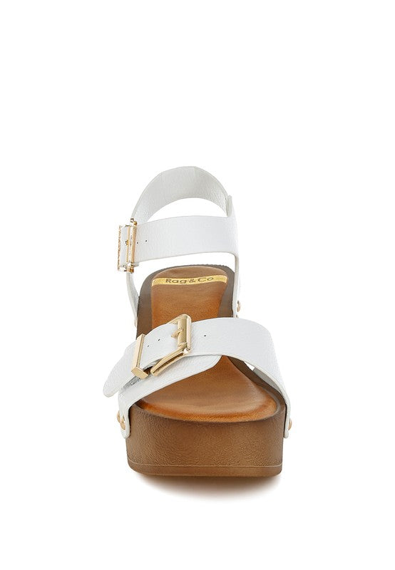 White leather clog sandals with cross straps and gold buckle closure