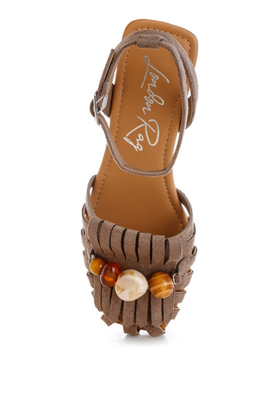 Taupe ankle-strap sandal showing side view with beaded fringe and square toe