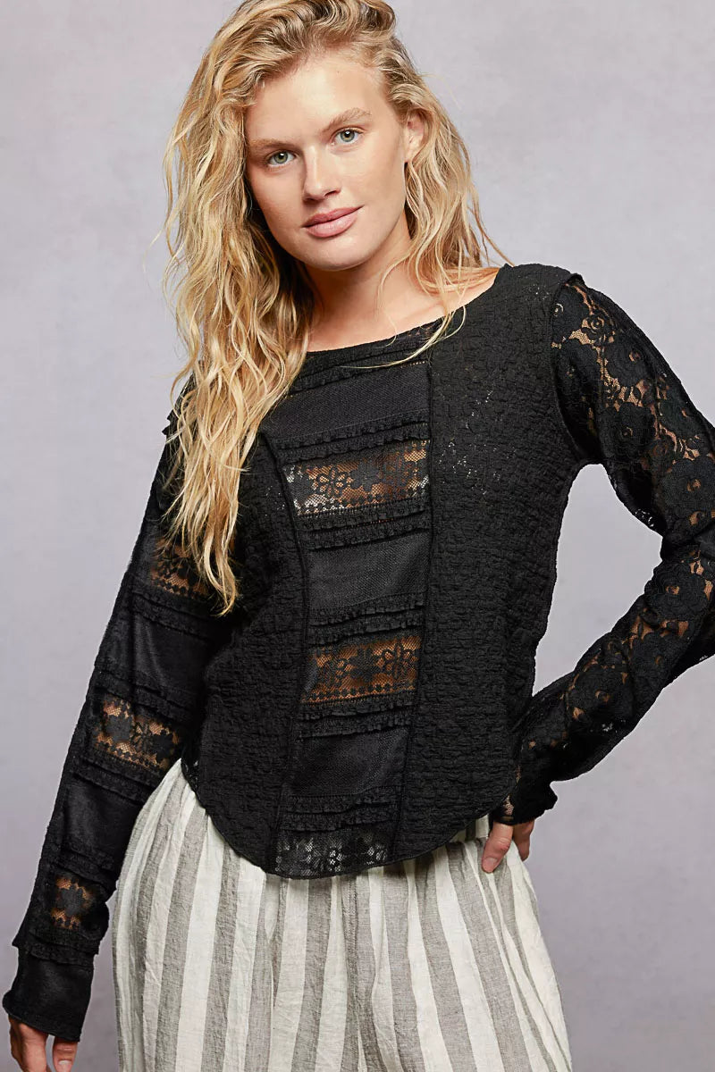 Black long sleeve exposed-seam top with lace sleeves and round neckline