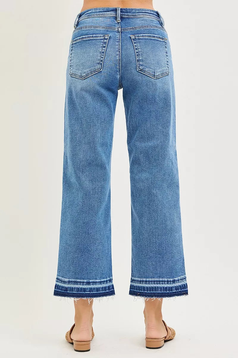 Back view of medium-wash slouchy cropped boyfriend jeans; two back pockets and hem cuff