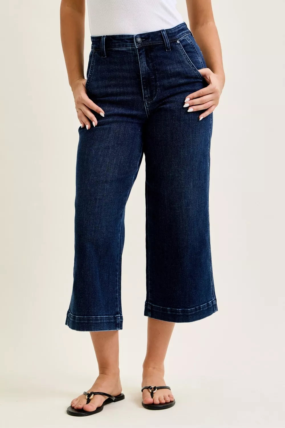 High-waist wide-leg ankle jeans, dark blue wash, front view with belt loops