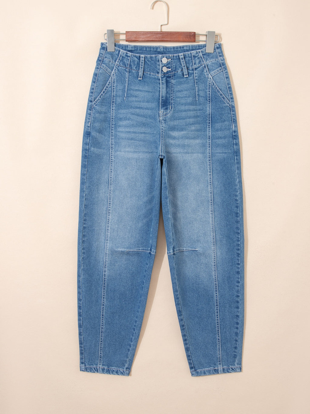 Medium-wash cuffed barrel jeans with button fly, belt loops, and patch hand pockets