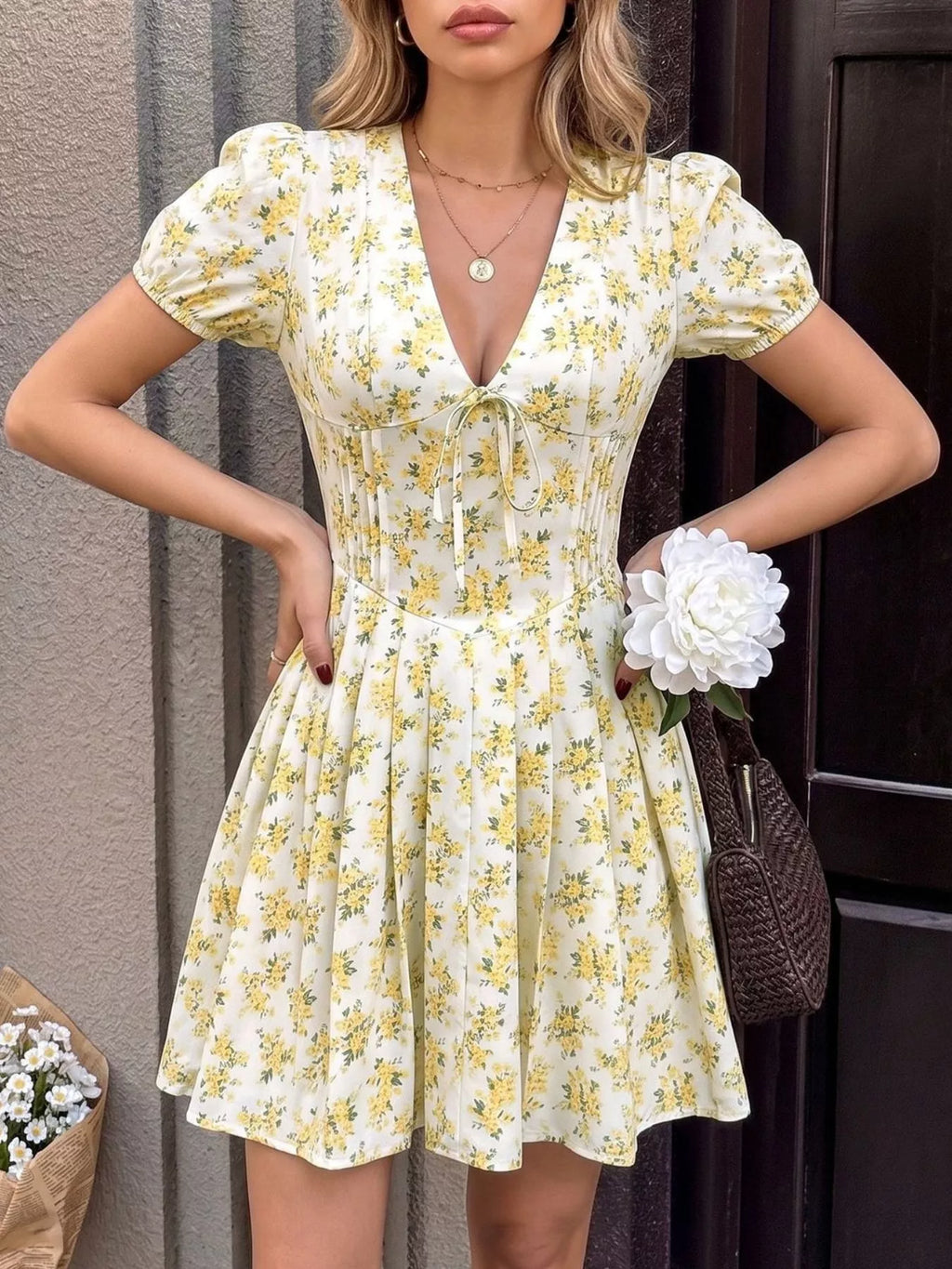 Yellow floral V-neck mini dress with tied waist and gathered skirt
