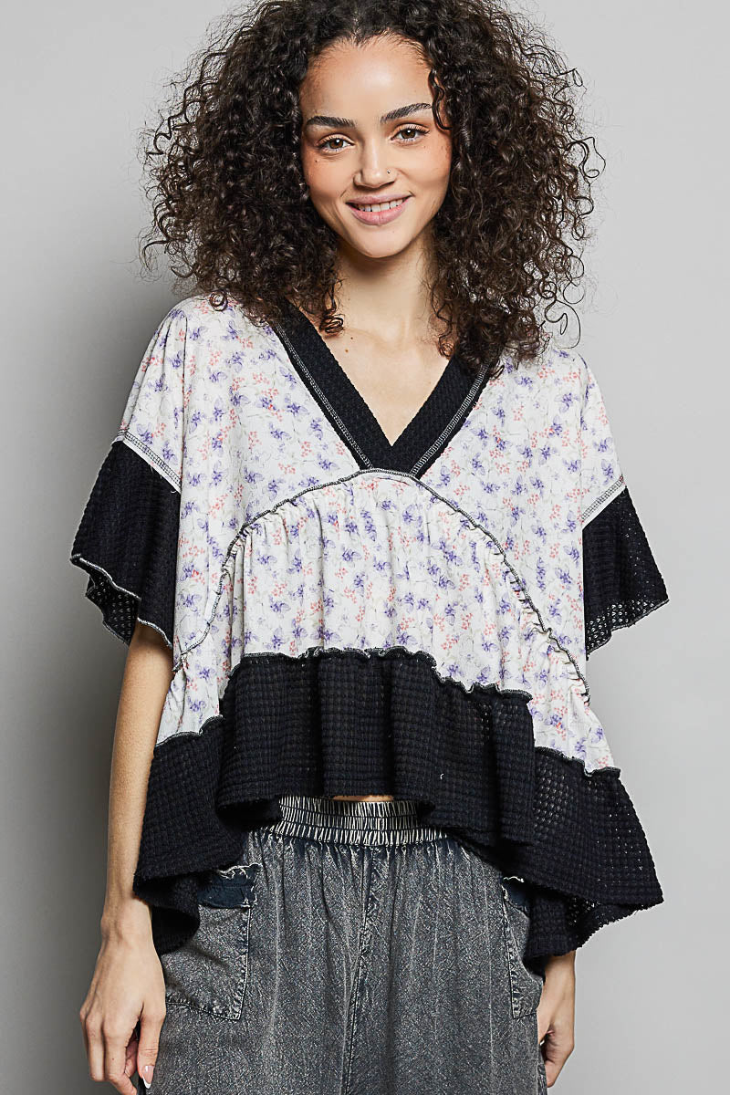 Floral print V-neck blouse with black trim, ruffled tiers, gentle gathers