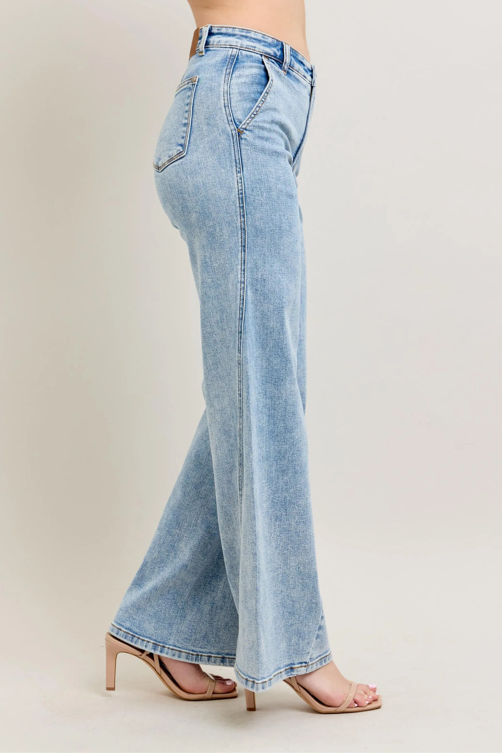 Light wash wide-leg jeans, angled side view with back pocket and center seam