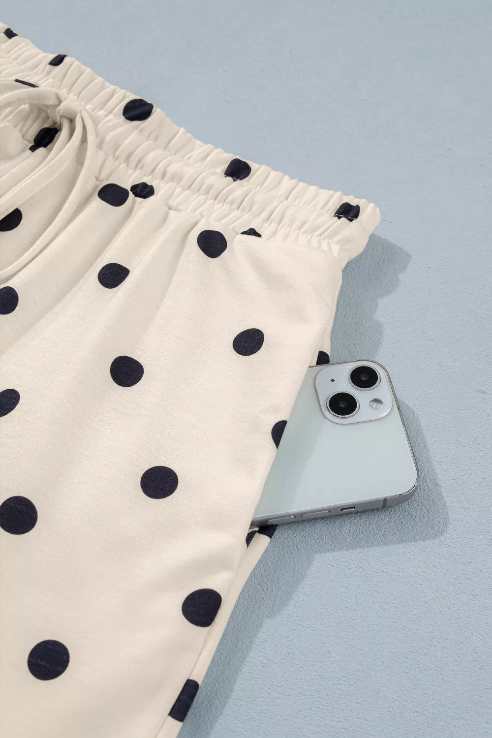 Cream polka dot shorts with gathered waist and elastic hem detail