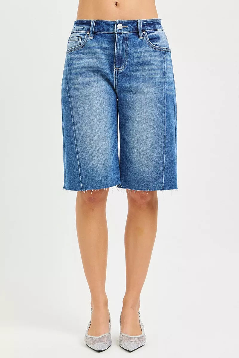 Slouchy seamed jorts in medium wash denim, front button fly, frayed raw hem, pockets