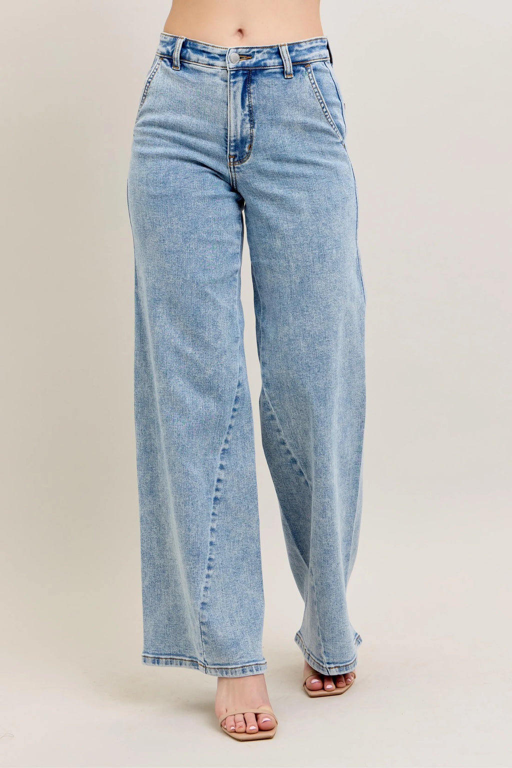 Light wash high-waist wide-leg jeans with skewed inseam and button closure
