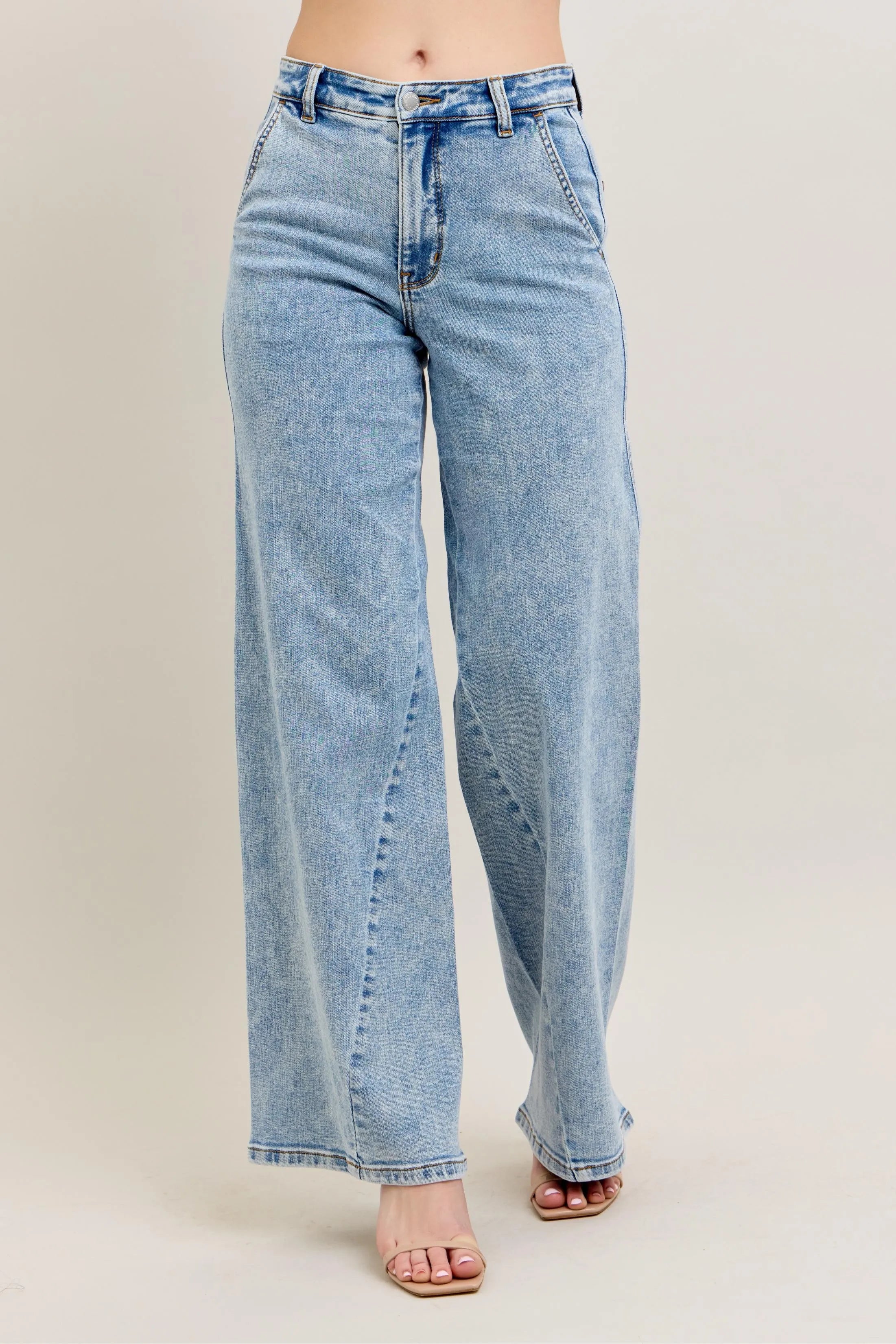 Light wash high-waist wide-leg jeans with skewed inseam and button closure