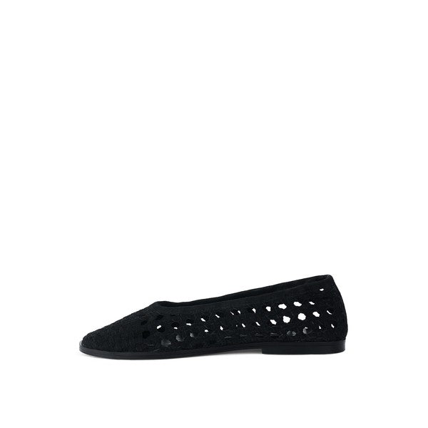 Black suede ballet flats, side view with perforated upper and flat low sole
