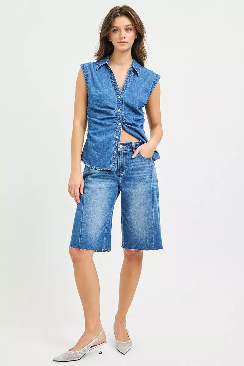 Slouchy seamed jorts in medium wash denim, button front, raw hem, patch pockets