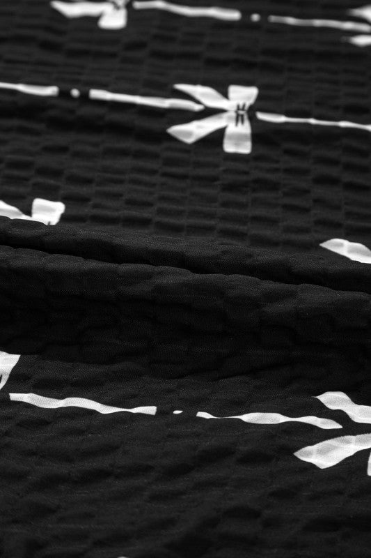 Black textured fabric with white bow stripe motif detail