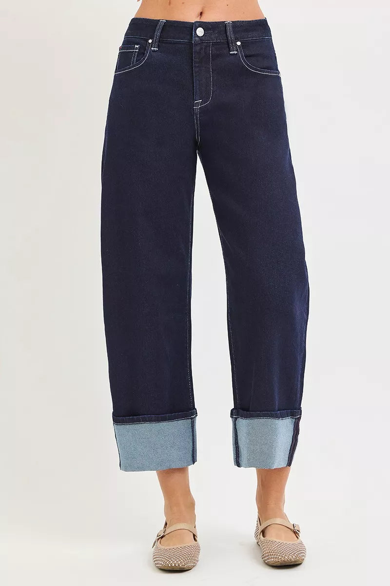 Front view of dark wash slouchy crop jeans with rolled cuff and light denim hem band