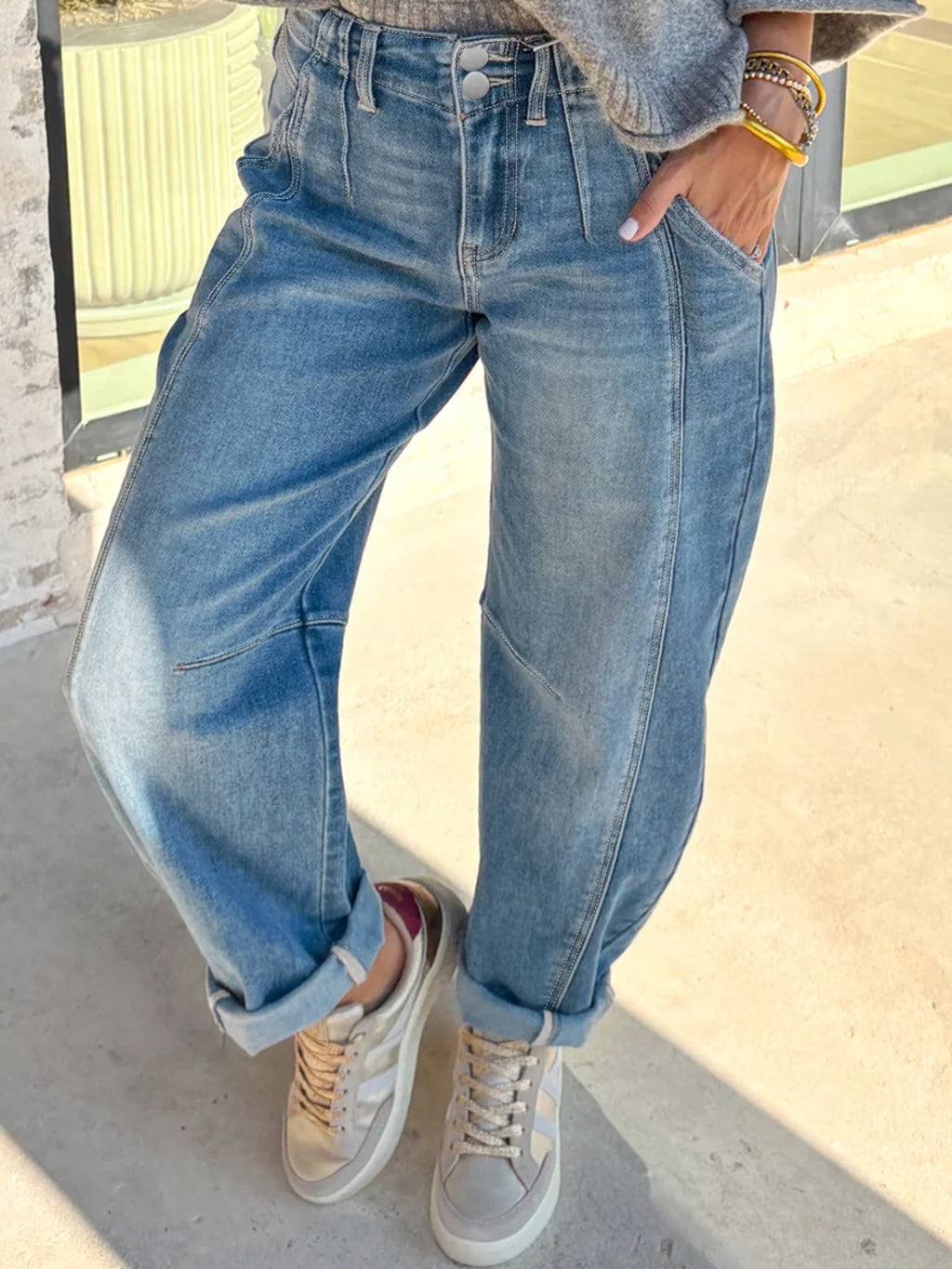 Medium-wash barrel jeans with button-and-zip waistband and cuffed hem