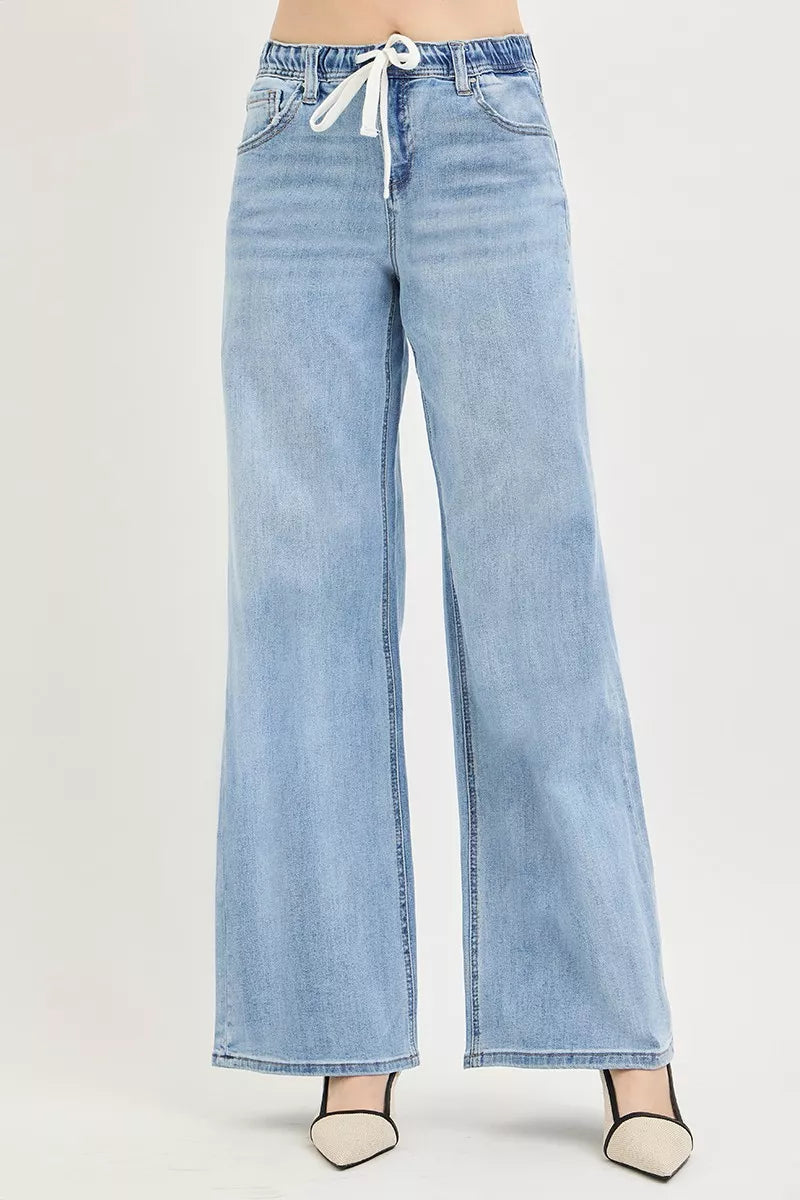 Light-wash wide-leg jeans with front fly, pockets, and tie-waist drawstring